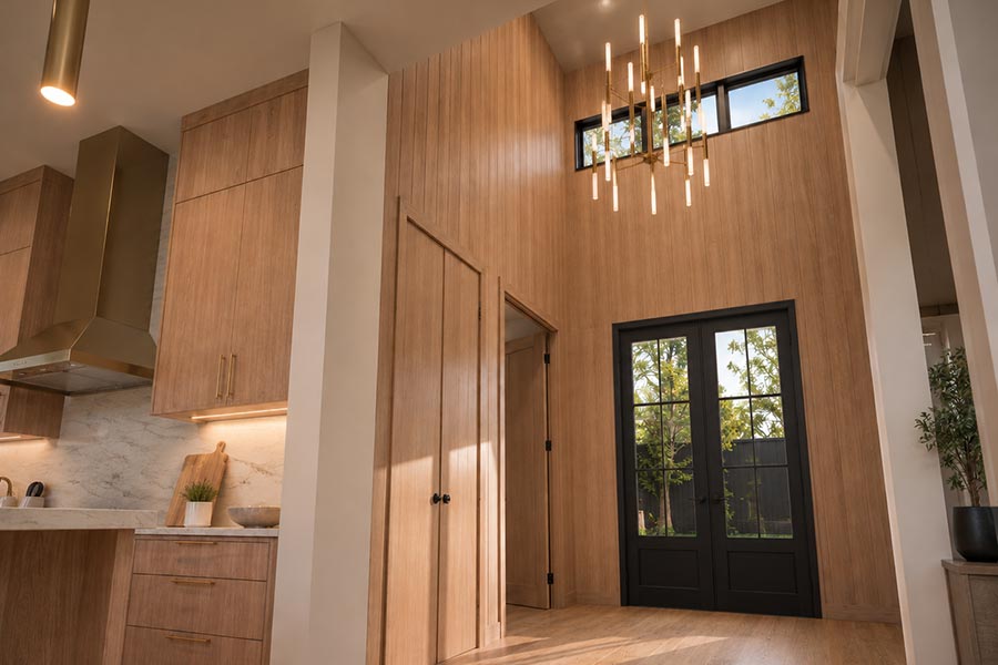 Entry with vaulted wood-paneled wall, brass chandelier, and black French doors beside the kitchen